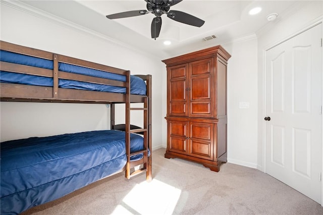 bedroom featuring light carpet, a closet, ceiling fan, and crown molding