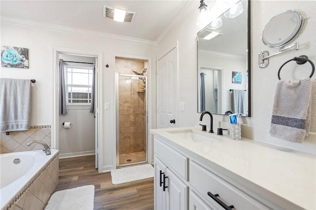 bathroom with vanity, plus walk in shower, ornamental molding, and hardwood / wood-style flooring