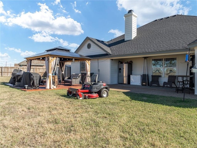 back of house with a gazebo, a patio, and a yard