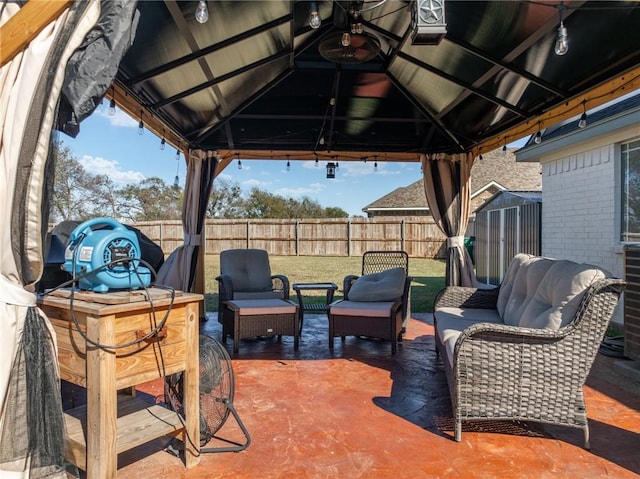 view of patio / terrace featuring a gazebo and a storage unit