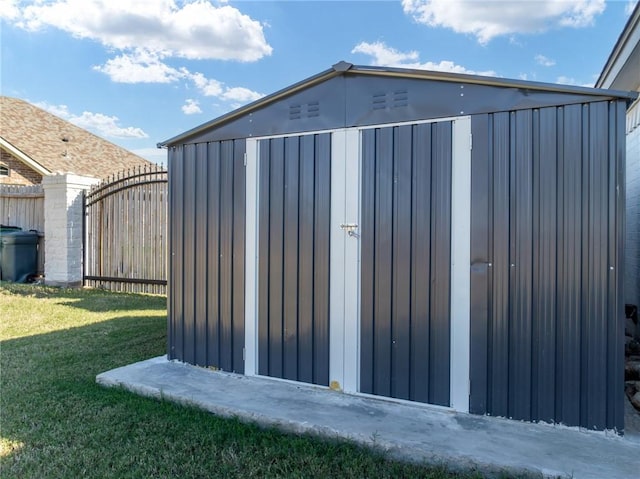 view of outbuilding featuring a yard