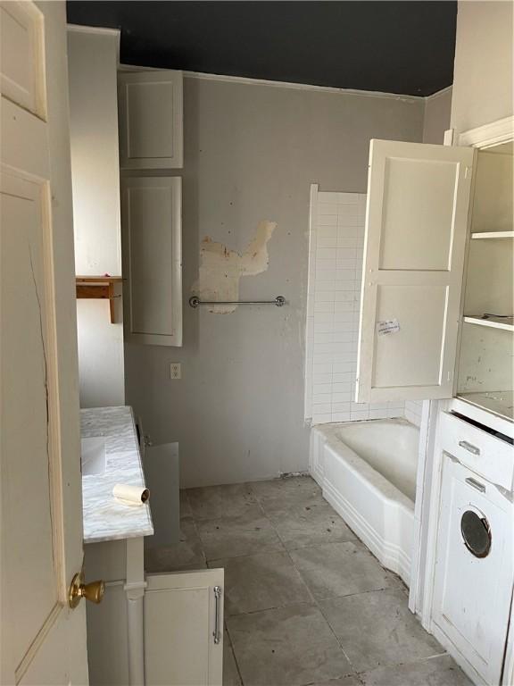 bathroom featuring a tub to relax in and vanity