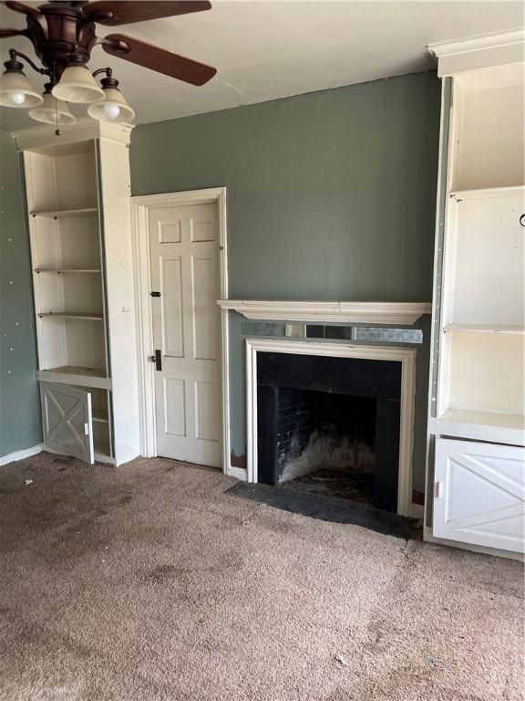 unfurnished living room with carpet flooring and ceiling fan