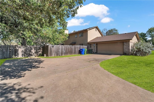 view of front of house featuring a garage and a front lawn