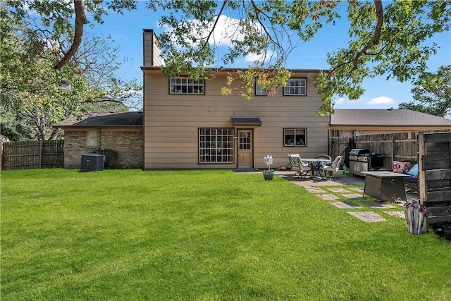 back of house featuring a patio, cooling unit, and a lawn