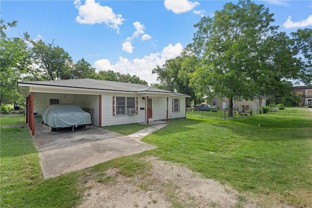 view of front of property featuring a carport, cooling unit, and a front lawn