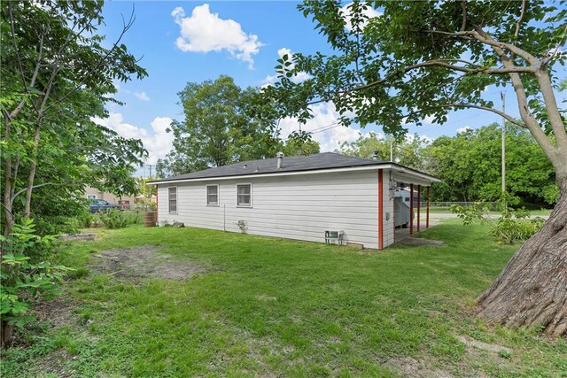 single story home featuring cooling unit, a front lawn, and a carport