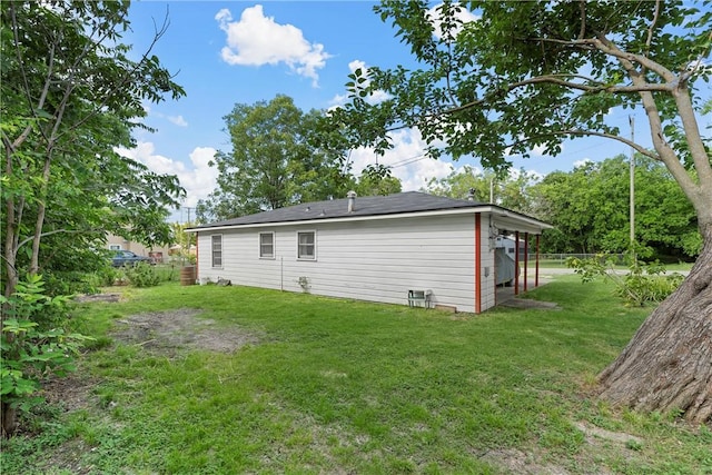 back of property featuring a yard