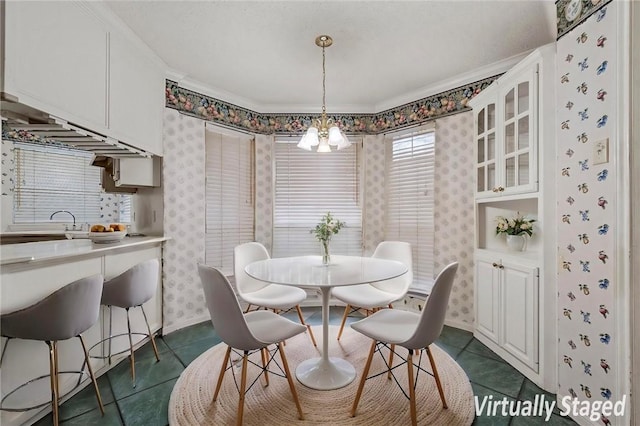 dining room featuring dark tile patterned flooring and a chandelier