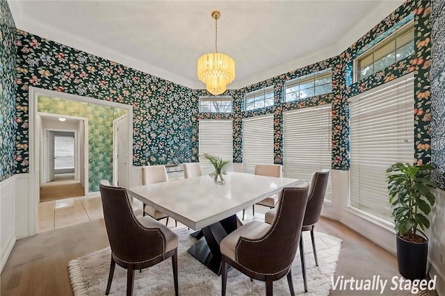 dining room featuring crown molding and a notable chandelier