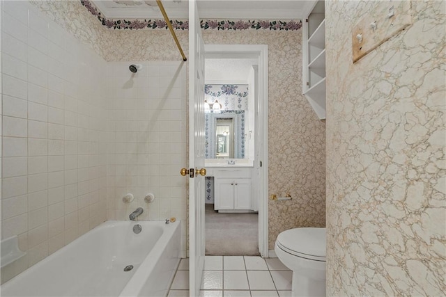 full bathroom with tiled shower / bath, tile patterned flooring, vanity, toilet, and crown molding