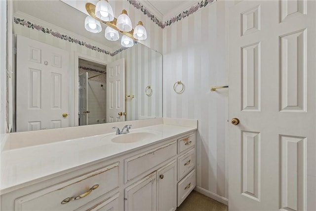 bathroom featuring vanity, crown molding, and walk in shower