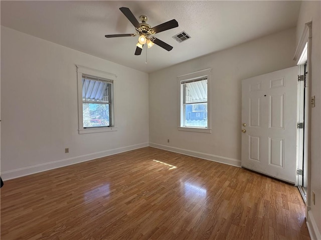 spare room with hardwood / wood-style floors and ceiling fan