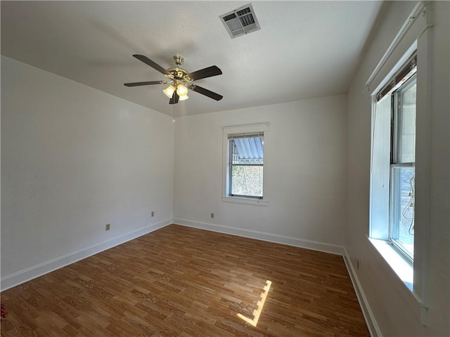 spare room featuring ceiling fan and dark wood-type flooring