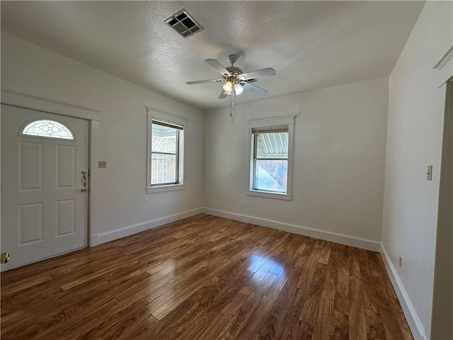 entryway featuring a textured ceiling, ceiling fan, and dark wood-type flooring