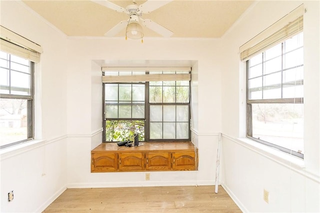 interior space with ornamental molding, light hardwood / wood-style floors, and ceiling fan