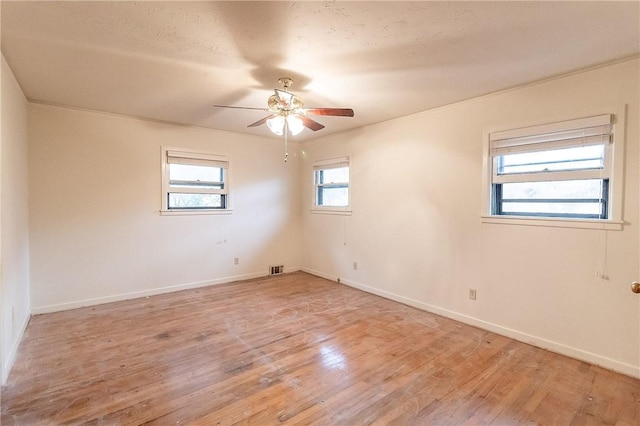 empty room featuring ceiling fan and light hardwood / wood-style floors