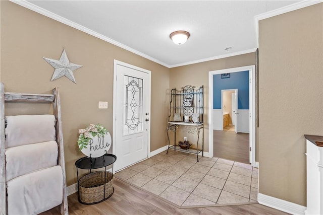 foyer entrance featuring light wood-type flooring, baseboards, and crown molding