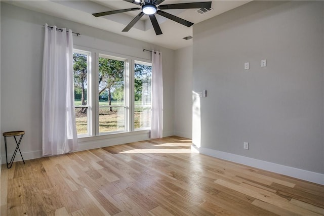 unfurnished room featuring light wood-type flooring, plenty of natural light, and ceiling fan