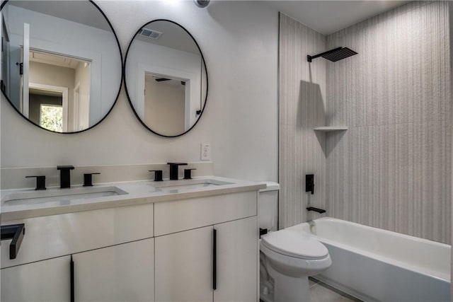 full bathroom with vanity, tiled shower / bath combo, and toilet