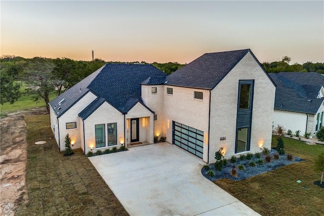 view of front of property featuring a lawn and a garage