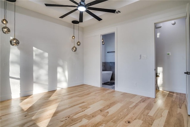 empty room featuring ceiling fan and light hardwood / wood-style flooring