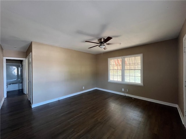 empty room featuring dark hardwood / wood-style floors and ceiling fan