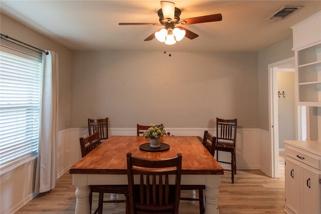 dining area with ceiling fan and light hardwood / wood-style flooring