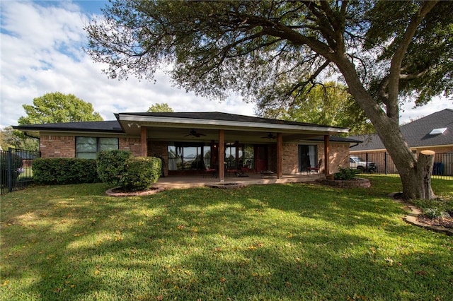 back of property featuring a yard, ceiling fan, and a patio area