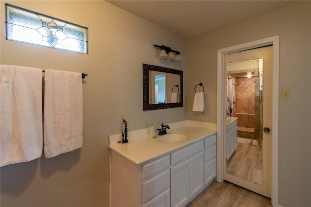 bathroom with a shower with curtain, vanity, and wood-type flooring