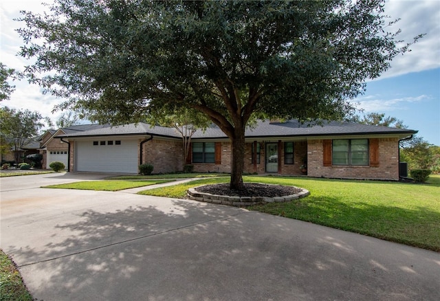 single story home featuring a front lawn and a garage