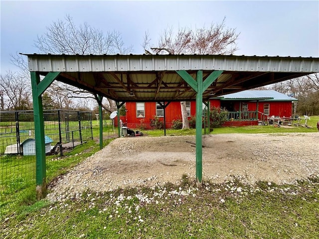 view of property's community with a detached carport and an outdoor structure