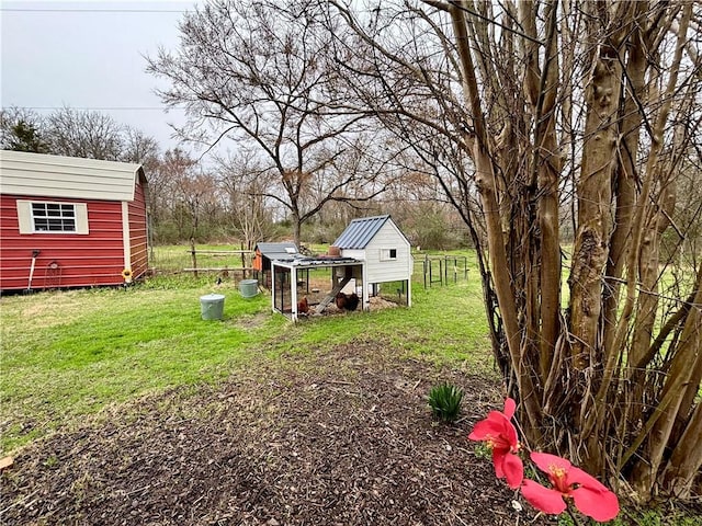 view of yard featuring exterior structure and an outbuilding