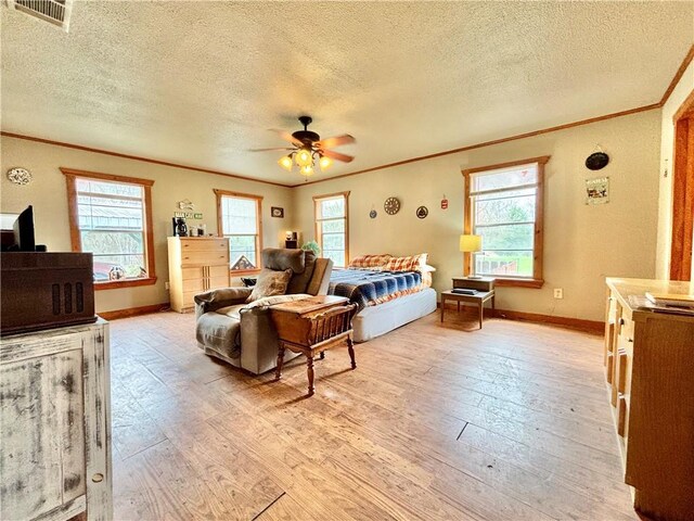 bedroom with light wood-style flooring, multiple windows, visible vents, and ornamental molding