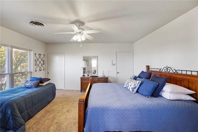 bedroom with ceiling fan and light colored carpet