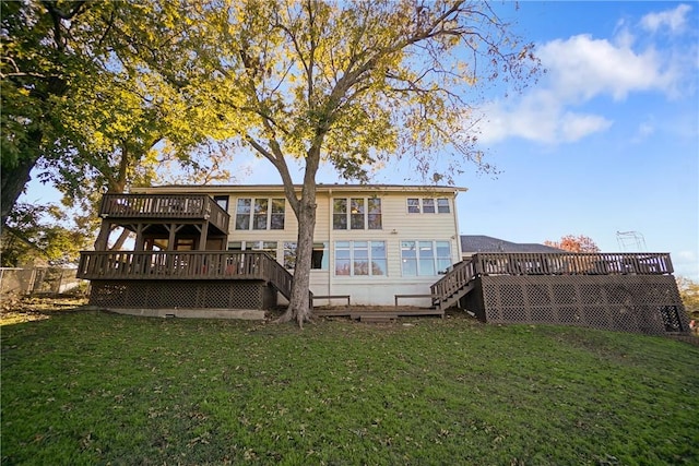 rear view of property featuring a lawn and a wooden deck