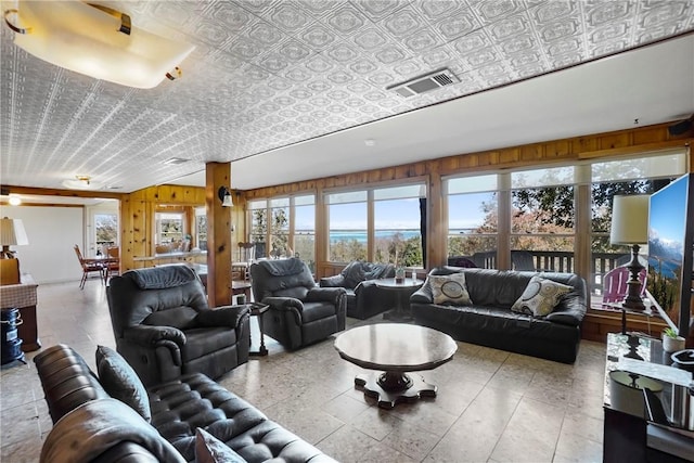 living room with wood walls and vaulted ceiling