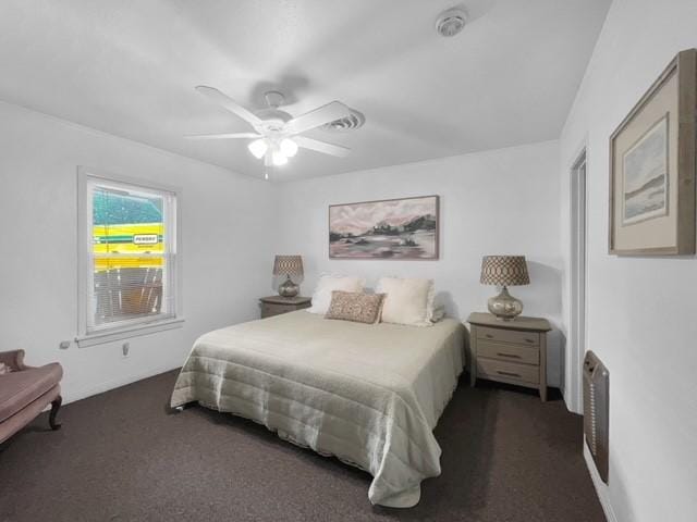 bedroom with dark colored carpet and ceiling fan