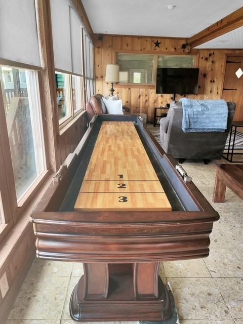 recreation room featuring wooden walls