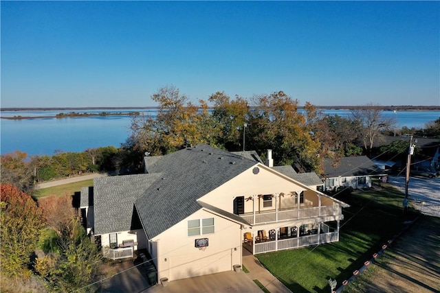 birds eye view of property with a water view