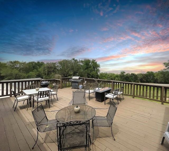 deck at dusk with an outdoor fire pit