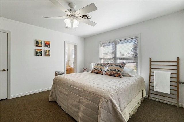 bedroom featuring dark colored carpet, ceiling fan, and ensuite bath