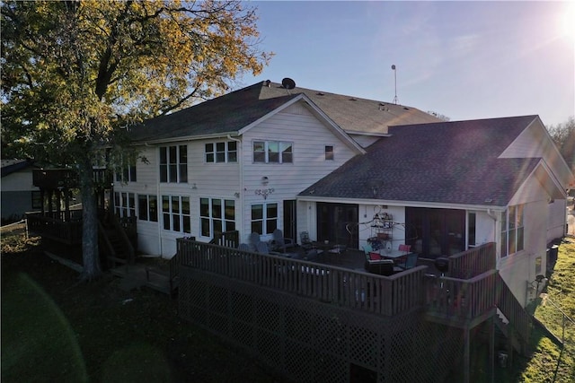 back of house featuring a wooden deck