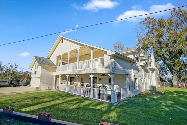 back of property featuring a lawn and a balcony