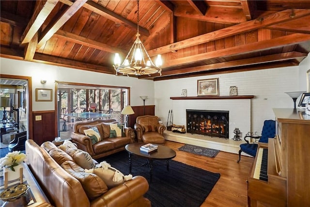 living room with wooden ceiling, an inviting chandelier, lofted ceiling with beams, wood walls, and hardwood / wood-style floors