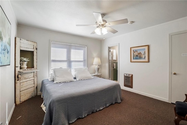 bedroom with ensuite bathroom, dark carpet, ornamental molding, heating unit, and ceiling fan