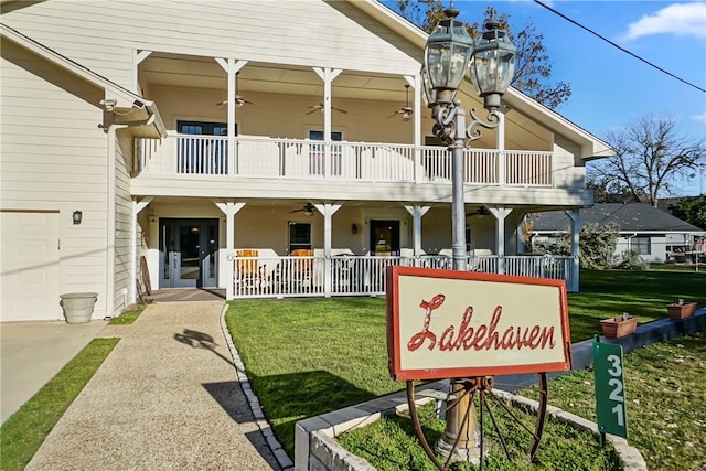 exterior space with a porch, a yard, and a balcony