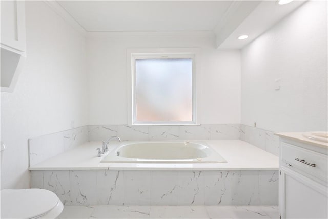 bathroom with vanity, a relaxing tiled tub, toilet, and crown molding