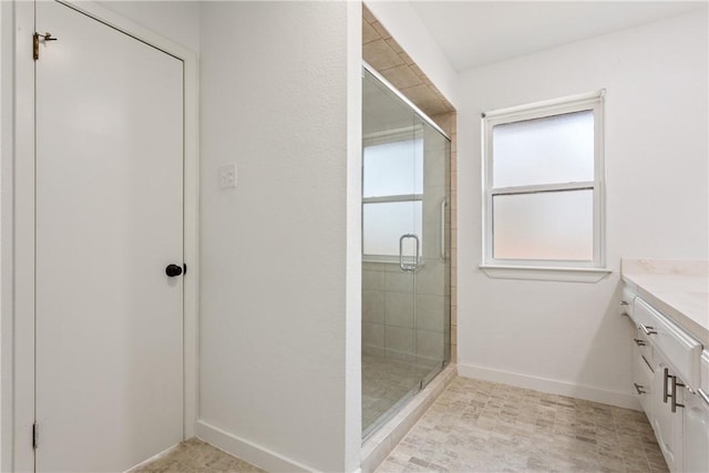 bathroom with a shower with door and vanity