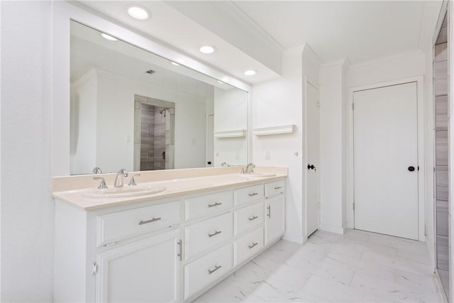 bathroom featuring vanity, crown molding, and walk in shower